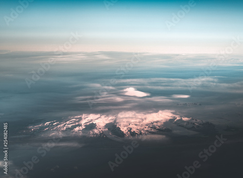 Fototapeta Naklejka Na Ścianę i Meble -  Aerial view of sunrise in winter nature landscape in north Iceland with glaciers in background. Snow Capped mountains and Glacier.
