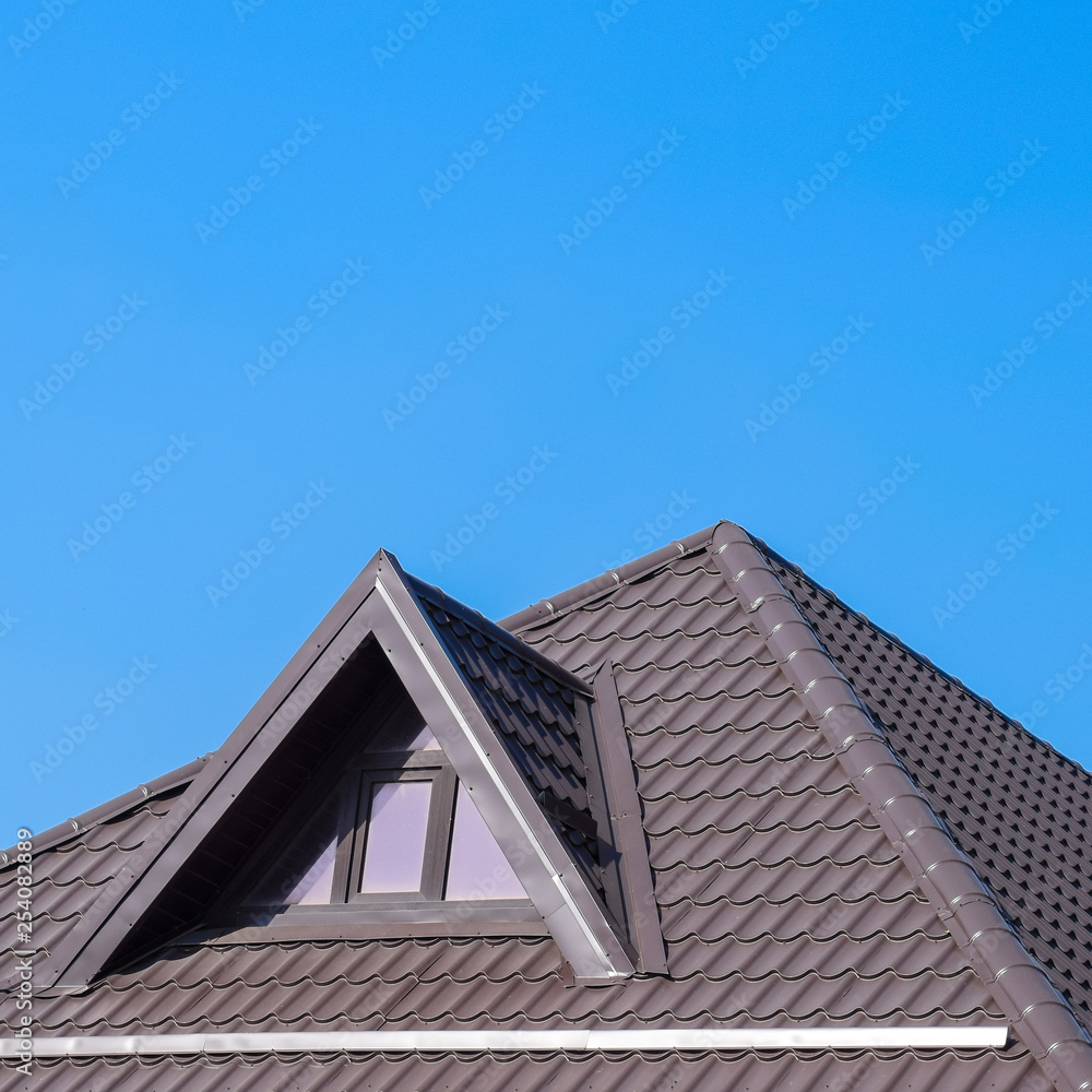 House with plastic windows and a brown roof of corrugated sheet