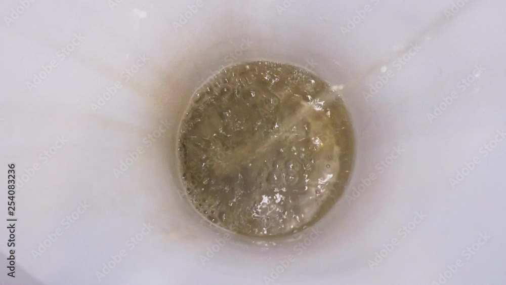 Man pissing in toilet and flushing close-up Man pissing in toilet and flushing close-up