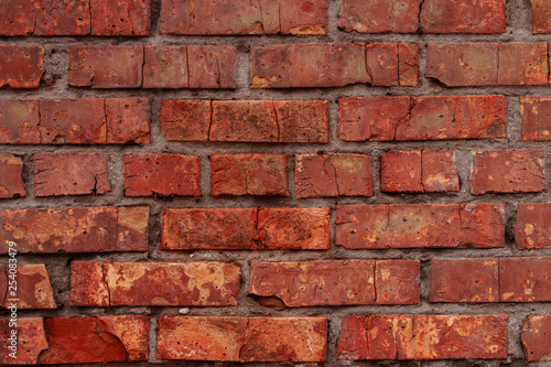 Old brick wall with scratches, cracks, dust, crevices, roughness. Can be used as a poster or background for design.