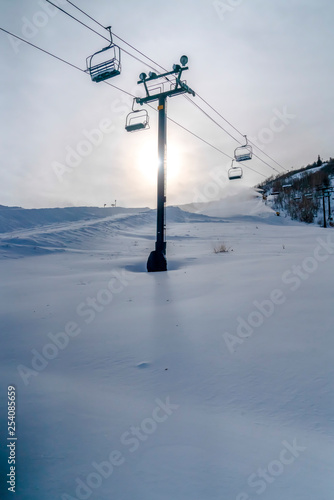 Bright sky over ski lifts and snowy mountain © Jason