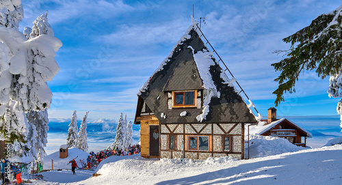 Poiana Brasov, Romania -16 January 2019:Wooden chalets and spectacular ski slopes in the Carpathians,Poiana Brasov,Transylvania,Romania,Europe,Pine forest covered in snow on winter season © DannyIacob