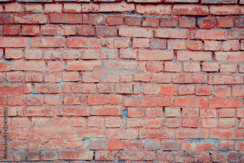 Old brick wall with scratches, cracks, dust, crevices, roughness. Can be used as a poster or background for design.