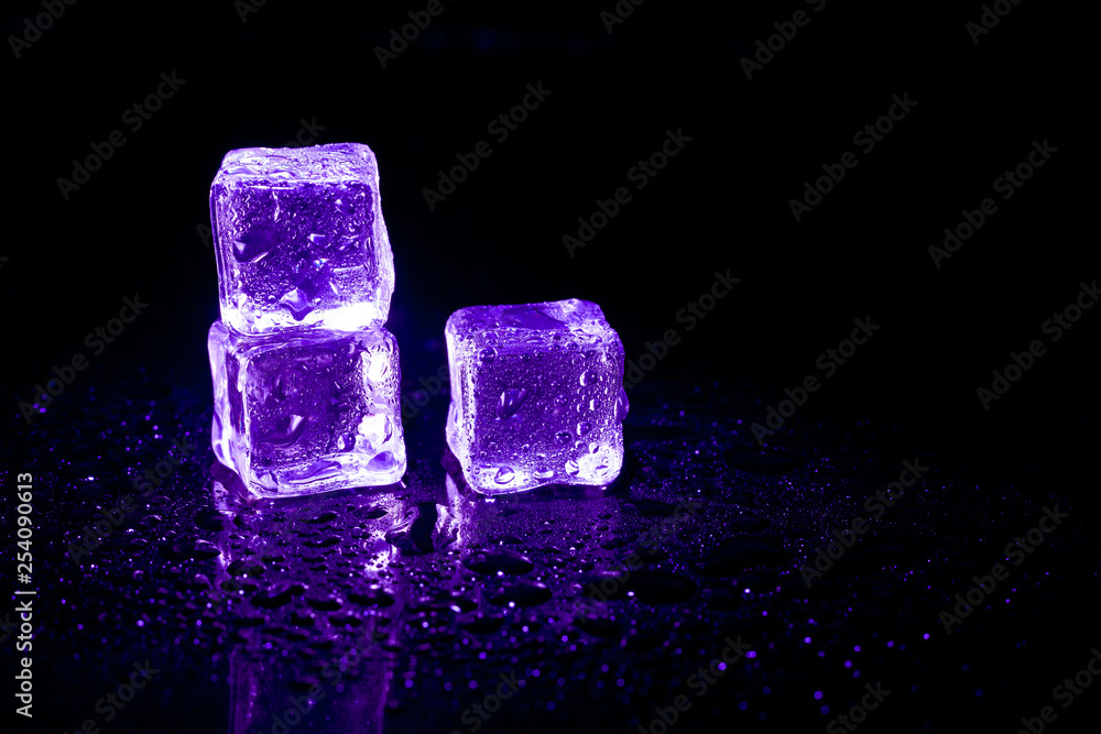Purple ice cubes reflection on black table background. Purple ice cubes reflection on black table background.
