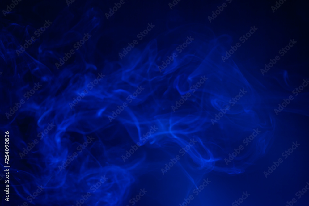 Blue smoke on black background.