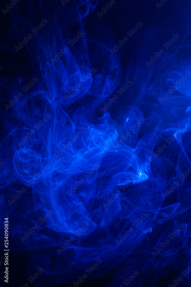 Blue smoke on black background.