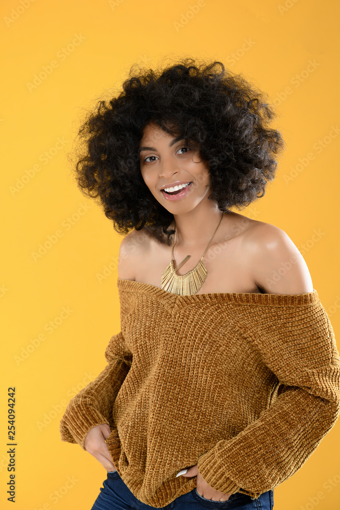 African American Woman with Curly Afro on Yellow Background African American Woman with Curly Afro on Yellow Background