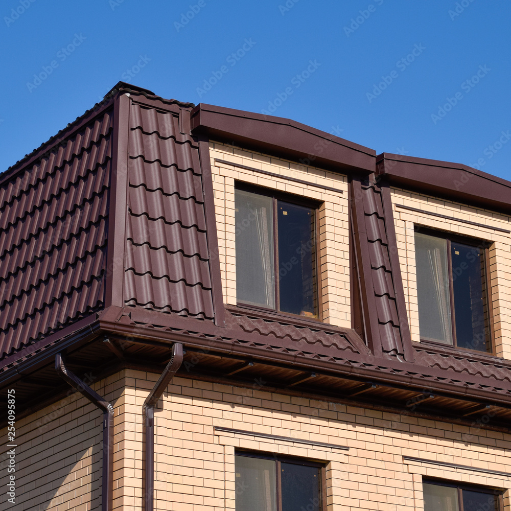 The house with plastic windows and a roof of corrugated sheet The house with plastic windows and a roof of corrugated sheet