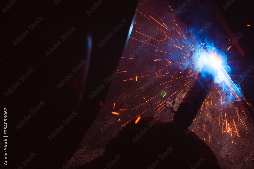Arc welding. Welding of two metal plates in inert gases. MIG / MAG. A
