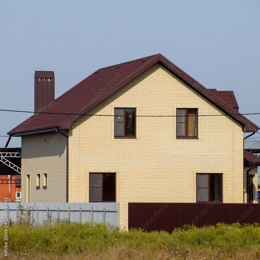 The house with plastic windows and a roof of corrugated sheet The house with plastic windows and a roof of corrugated sheet
