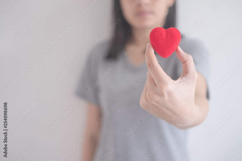 beautiful Asian woman show red heart isolated on a white background with copy space beautiful Asian woman show red heart isolated on a white background with copy space