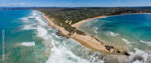 Aerial panoramic view of the Point Roadknight limestone rock outcrop with the beach, coastline and houses in Anglesea Victoria, Australia photo