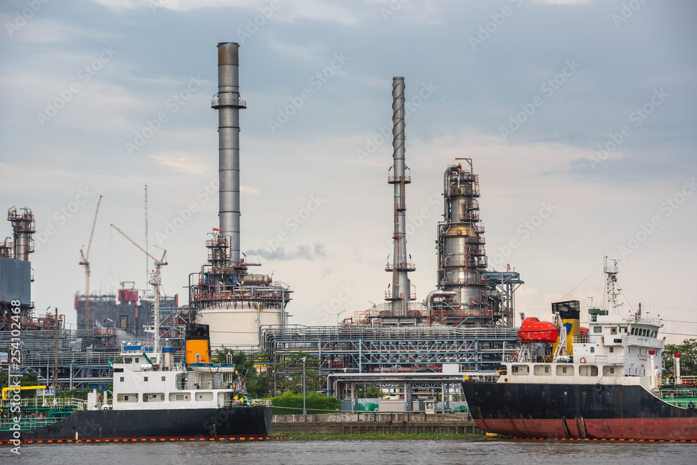 Landscape of Oil and Gas Refinery Manufacturing Plant., Shipping Dock and Chemical Distillation Process Buildings., Factory of Power and Energy Industrial at Twilight Sunset., Engineering Petroleum.