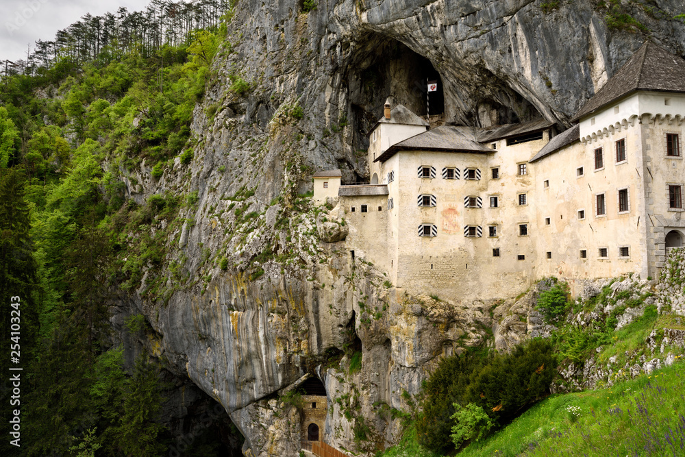 Cliff cave forest and entrances at Predjama Castle 1570 Renaissance fortress built into the mouth of a cliffside cave in Slovenia