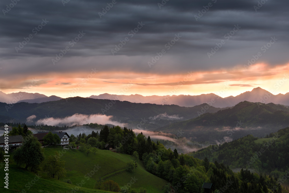 Sunrise with mist over the mountains of Kamnik Savinja Alps with Storzic peak on right in Skofjelosko Hills near Ljubljana Slovenia