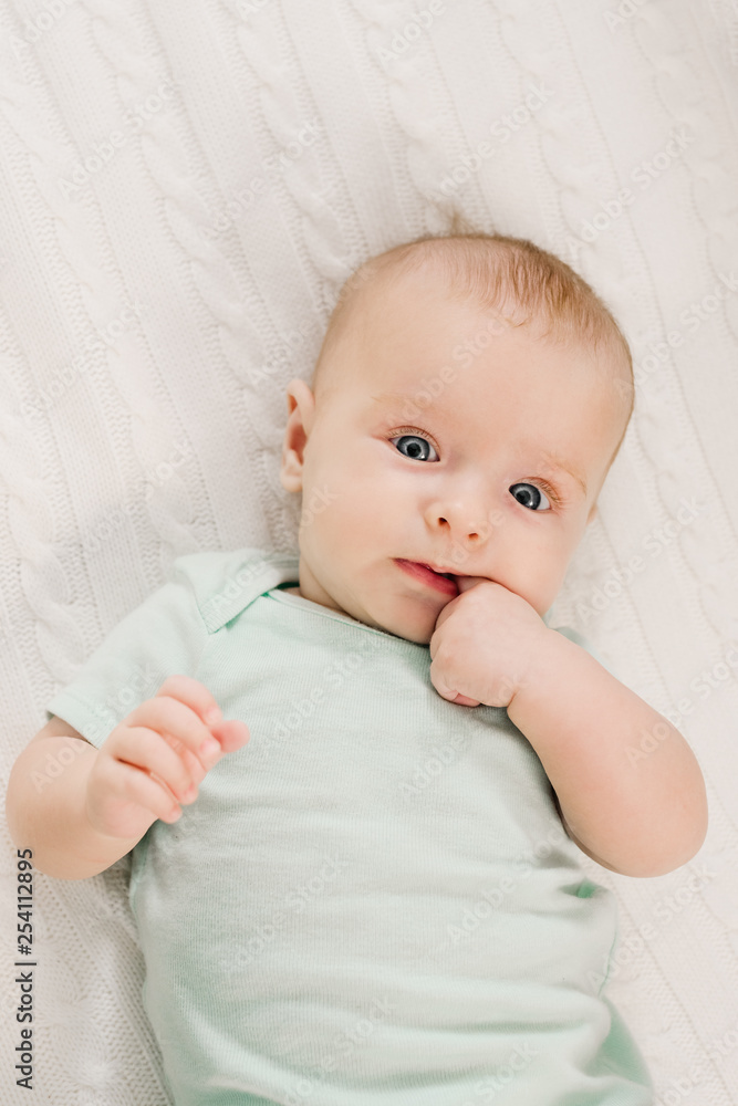 Portrait of cute newborn little baby lying in bed Portrait of cute newborn little baby lying in bed