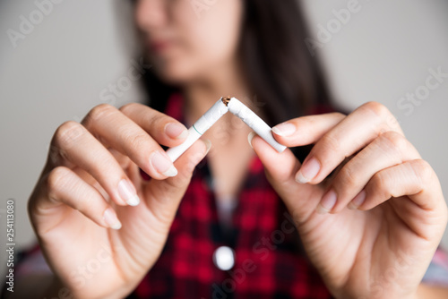 Soft focus of woman hand breaking  crushing or destroying cigarettes. World No Tobacco Day  May 31. STOP Smoking.