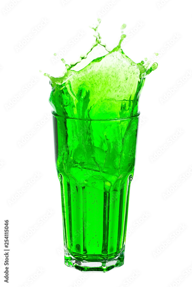 Green soda splashing out of glass isolated on white background. Green soda splashing out of glass isolated on white background.