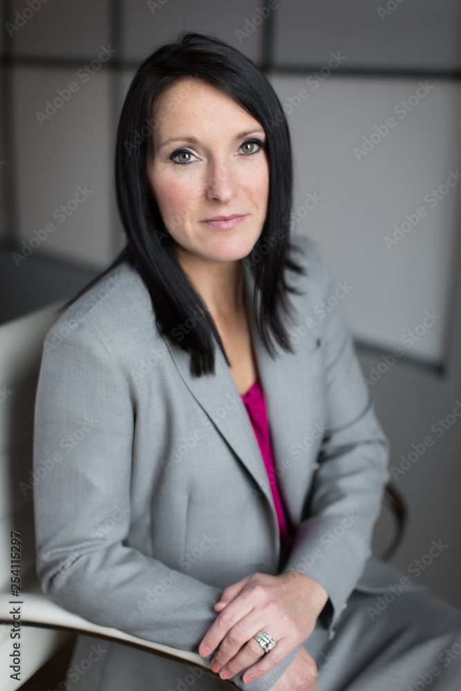 Serious Business Woman Sitting in White Chair Serious Business Woman Sitting in White Chair
