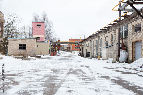 Old industrial factory and broken buildings. Snow and cold. Travel photo 2019.