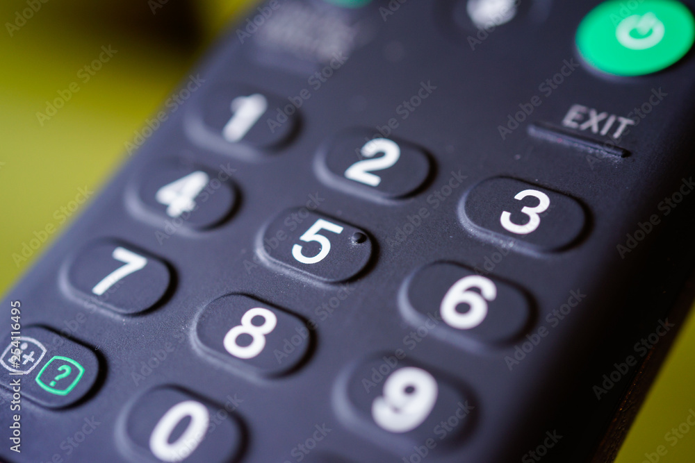 Man holding tv remote commander and number channel Man holding tv remote commander and number channel