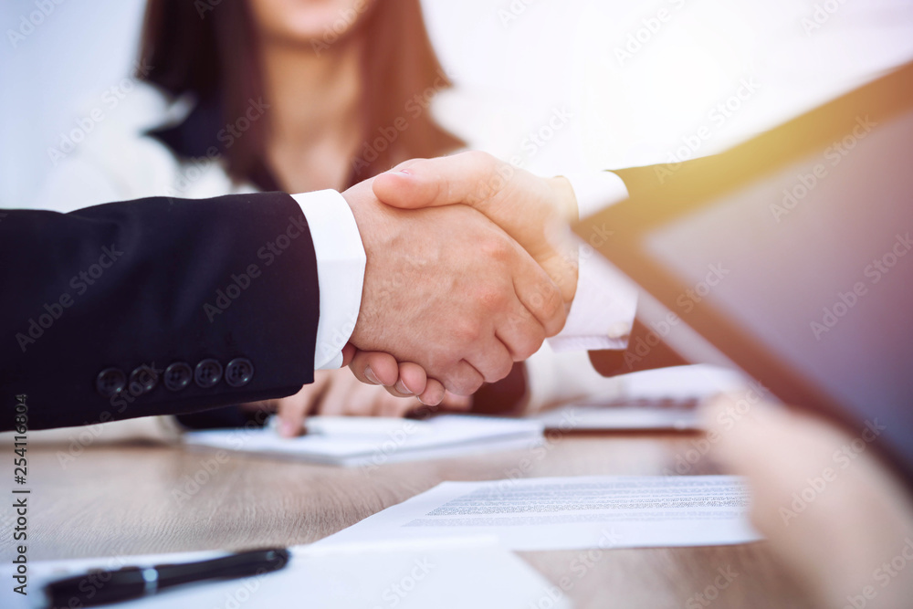 Business people shaking hands at meeting or negotiation in the office. Handshake concept. Partners are satisfied because signing contract Business people shaking hands at meeting or negotiation in the office. Handshake concept. Partners are satisfied because signing contract