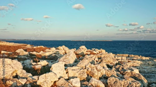 Beautiful sunset at Cres Island rocky coast. Croatia. Aerial view traveling low flying