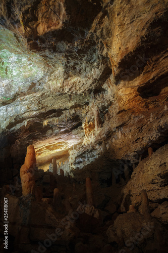 The cave is lit by artificial light