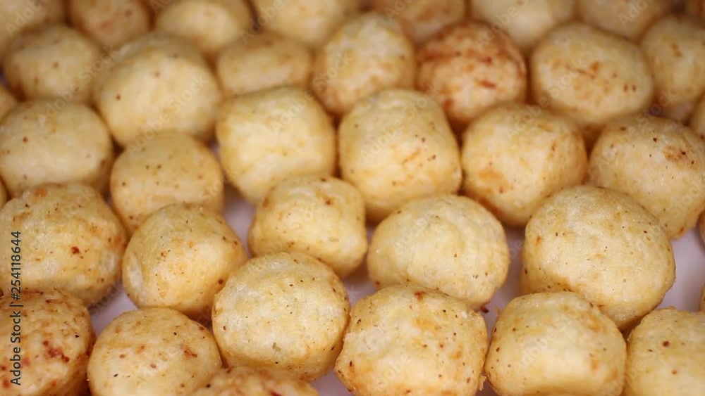 Millet ball gluten free balls closeup texture video on rolling rotating looping plate Millet ball gluten free balls closeup texture video on rolling rotating looping plate