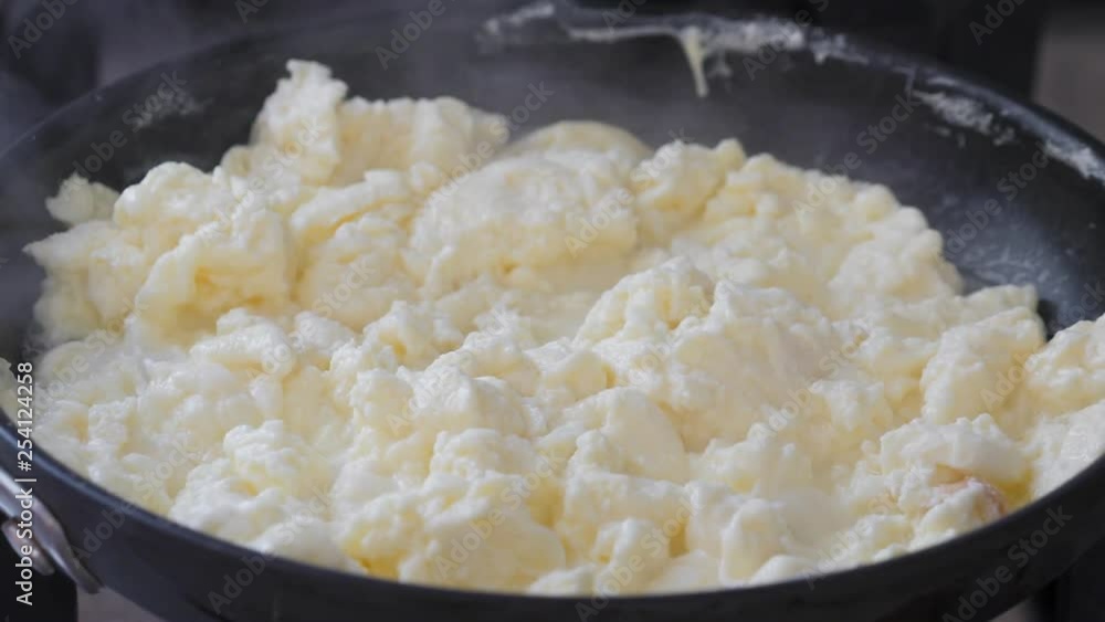 Cooking scrambled eggs on frying pan. Breakfast Cooking scrambled eggs on frying pan. Breakfast