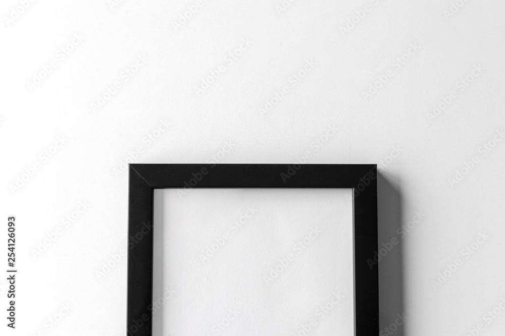 blank black picture frame on white table background. top view blank black picture frame on white table background. top view