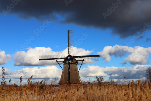 windmill of kinderdijk , beautiful netherlands landscape with sky and clouds background, historical travel photo