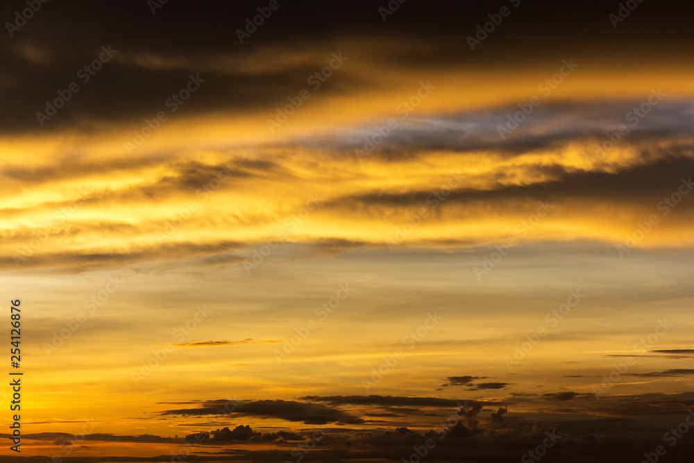 Beautiful golden sunshine reflect and spread with sky and dark cloud at asia
