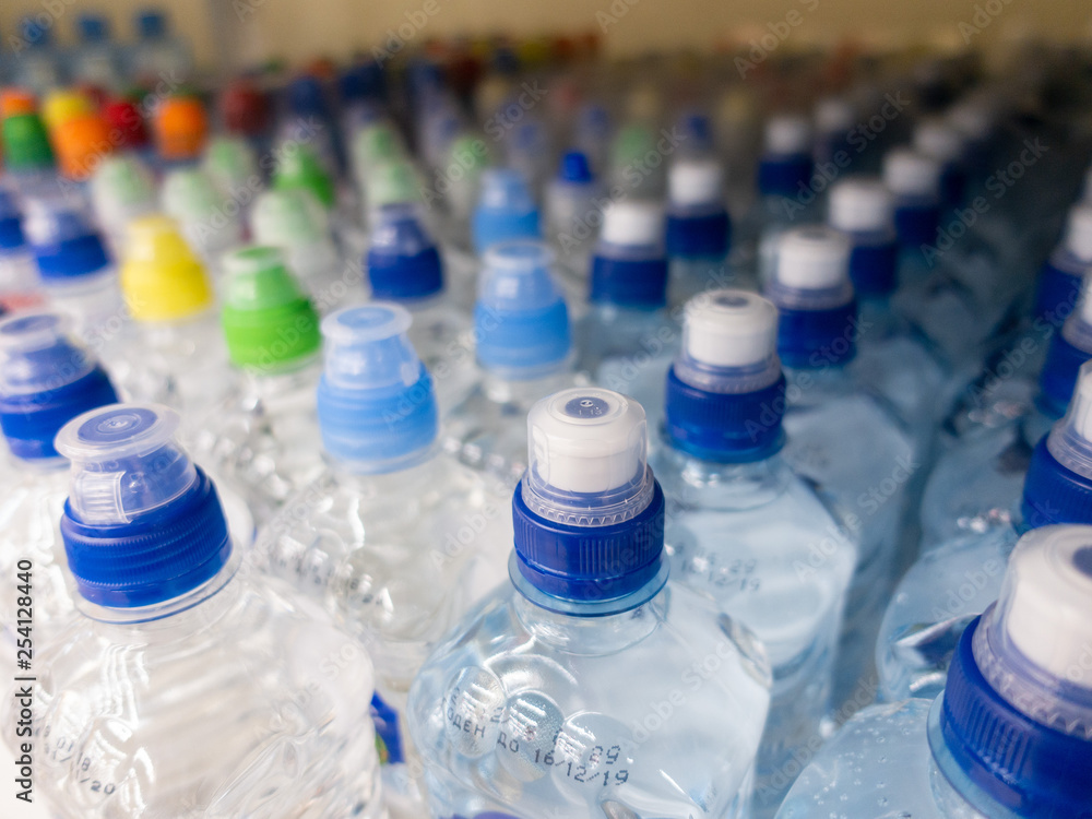 Lid plastic water bottle in the market. multi-colored plastic bottle caps Lid plastic water bottle in the market. multi-colored plastic bottle caps