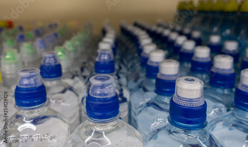 Lid plastic water bottle in the market. multi-colored plastic bottle caps  © Funtap