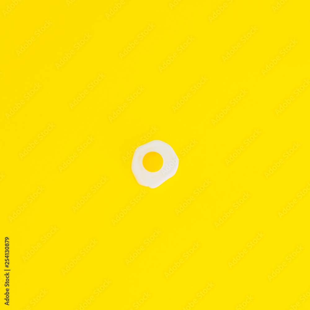Fried eggs or omelettes on a yellow background. The concept of minimalism. Fried eggs or omelettes on a yellow background. The concept of minimalism.