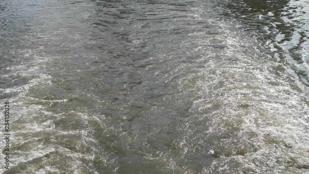 Ship wake on the river, Water foam trace behind the large ship goes, 4k video, slow motion. Ship wake on the river, Water foam trace behind the large ship goes, 4k video, slow motion.