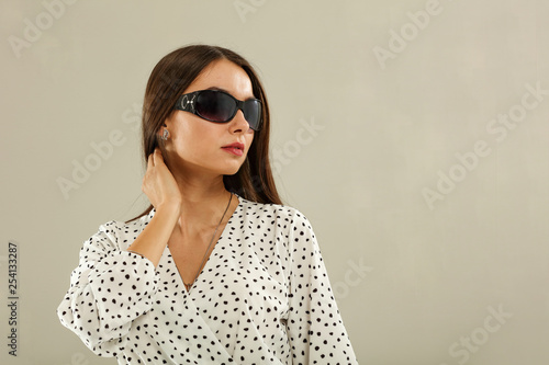 Slim young woman and summer sunglasses 