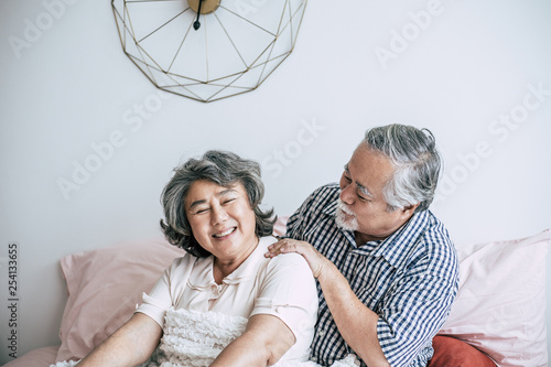 Senior man giving a massage to his wife