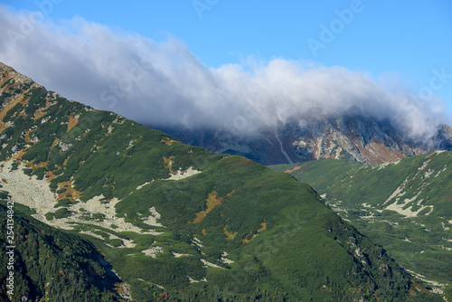 Tatra mountain peaks with tourist hiking trails in sunny summer day