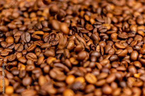 Coffee beans bright saturated texture. Roasted coffee beans background.