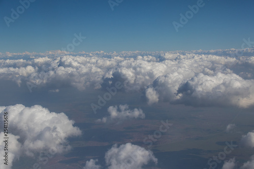 View from an aircraft window travelling high above the clouds image for background use with copy space in landscape format