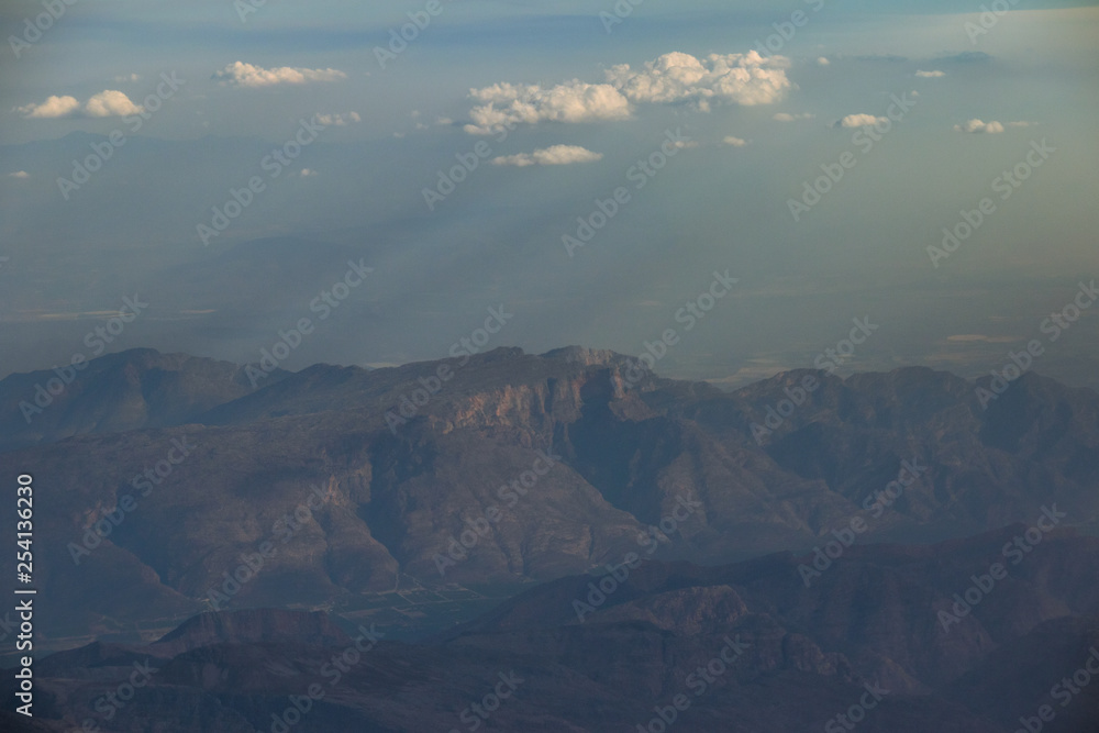 View from an aircraft window travelling high above the clouds image for background use with copy space in landscape format View from an aircraft window travelling high above the clouds image for background use with copy space in landscape format