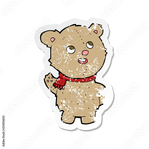 retro distressed sticker of a cartoon cute teddy bear with scarf