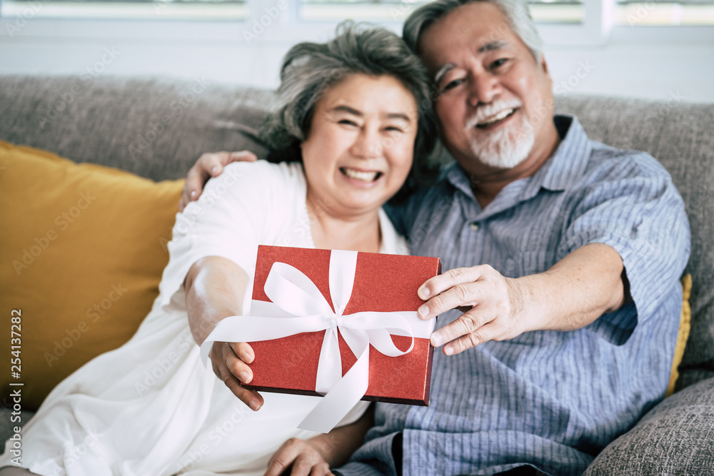 Elderly Couples Surprise and gift box at living room Elderly Couples Surprise and gift box at living room
