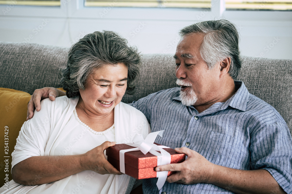 Elderly Couples Surprise and gift box at living room Elderly Couples Surprise and gift box at living room