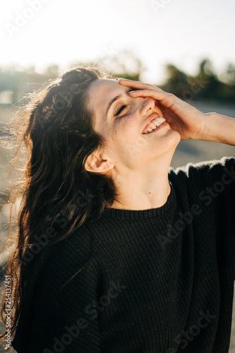 Portrait of a smiling attractive woman during sunset