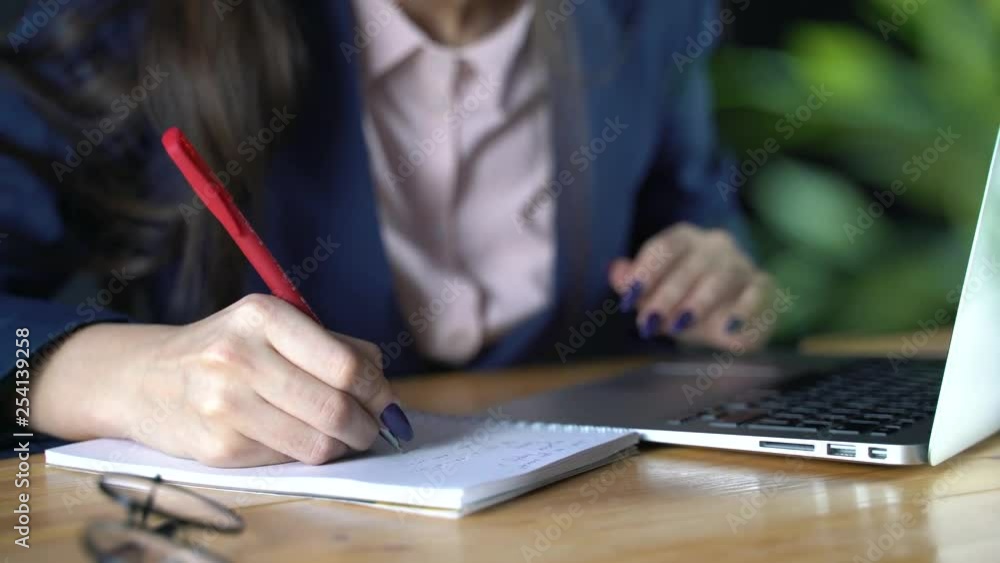 The businessman girl is preparing to write down important information in a notebook The businessman girl is preparing to write down important information in a notebook