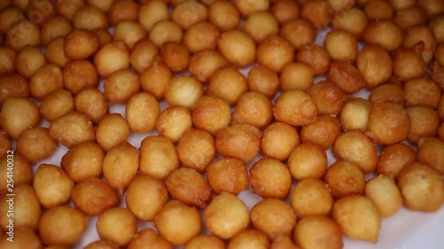 Soup balls closeup texture video on rolling rotating looping plate photo