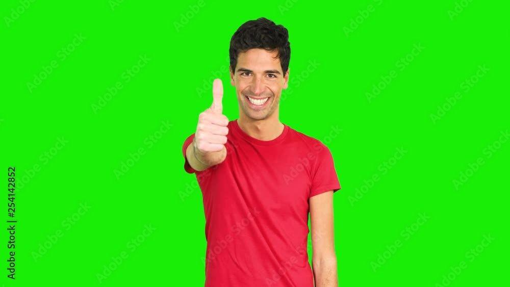 Handsome young man giving thumbs up, green screen chroma key Handsome young man giving thumbs up, green screen chroma key